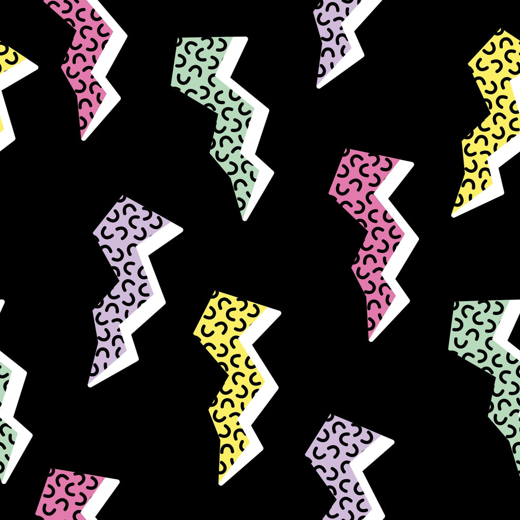 Saved By the Binky Jams Big Kids close-up of a  vibrant lightning bolt pattern in pastel colors including yellow, green, pink, and purple  against black background.