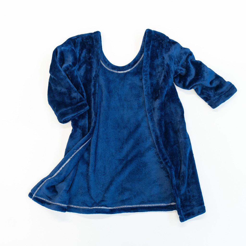 A back view of  deep blue velvet-textured car seat blankie. The blankie is open, showing the interior lining. It is laid flat against a plain white background.