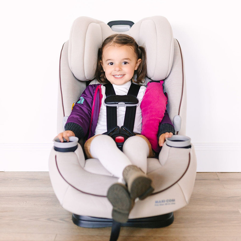 The Jam/Maroon
Little girl with brown hair and brown eyes is sitting in a beige carseat.  She is wearing a purple car seat coat that is open to show the buckled harness.  