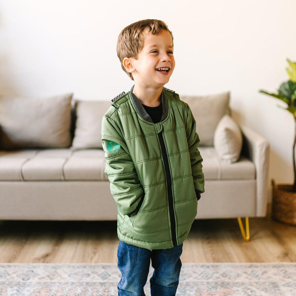 Puff/Green
Little boy with brown hair is wearing a green carseat coat with his hands in the pockets.  The coat is zipped and the boy is giggling.