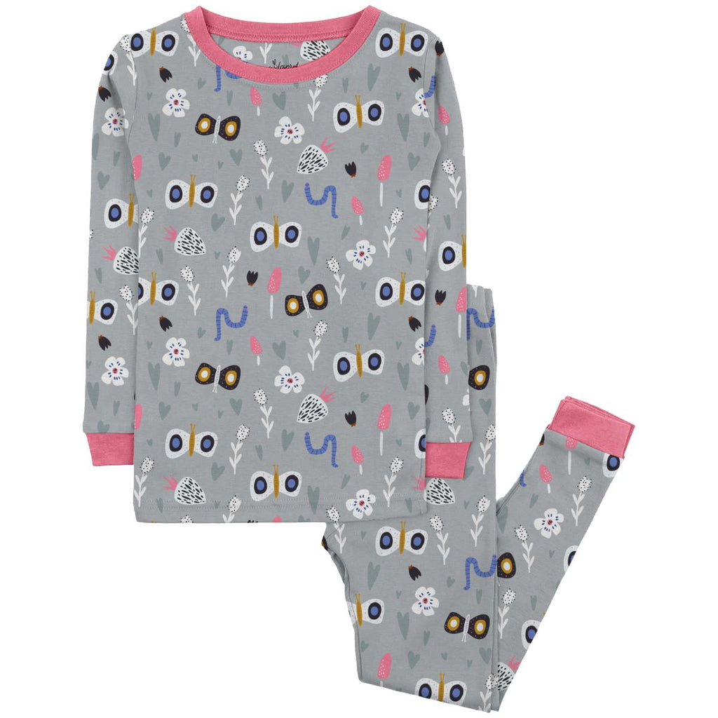 Flutterby Jams Big Kids a gray pajama set with a whimsical pattern with various colorful images and shapes. The pattern includes stylized butterflies with large wings, small white flowers, pink mushrooms, blue worms, and gray hearts in different sizes. The pajama top has long sleeves with  pink cuffs matching pink neckline. The pajama pants have an elastic waistband and dark pink trim,  laid out against a plain white background.